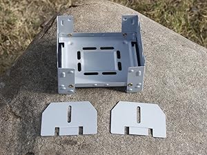 Main stove body with two modular side panels laid out for assembly