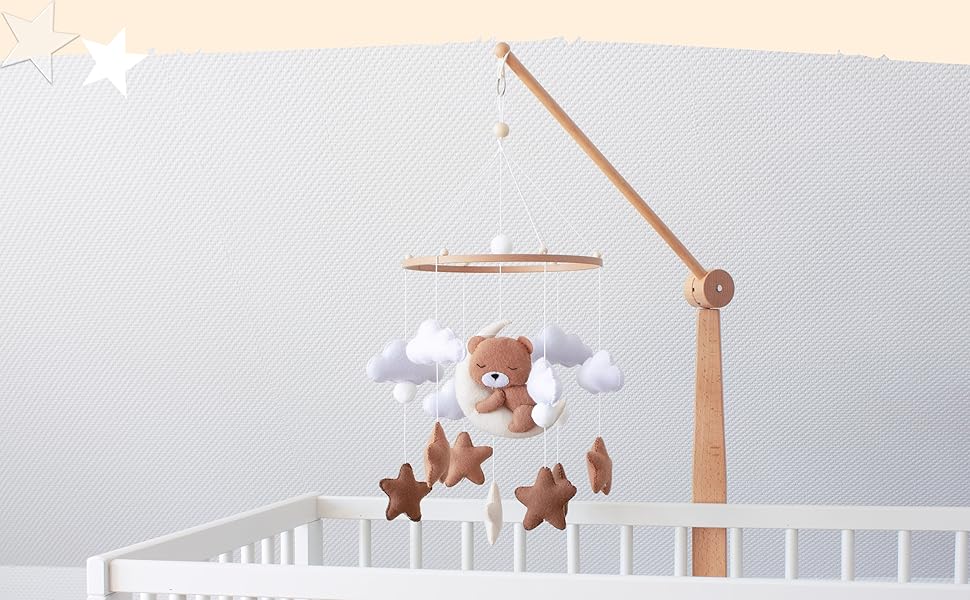 Mobiles Babybett mit Holzarm mit hängendem Teddybär, Wolken und Sternen in neutralen Farben