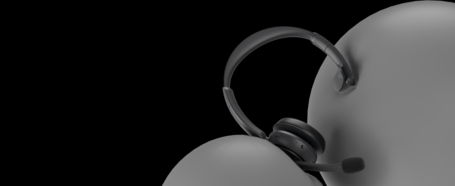 Close-up product photo of black headphones against dark background, showing minimal design details.