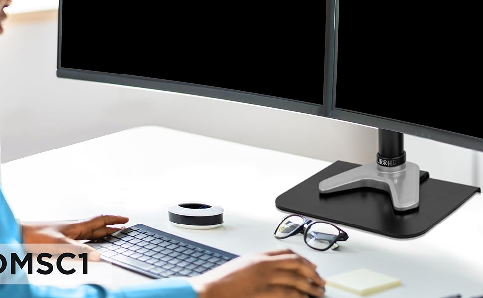 DMSC1 reinforcement plate installed on edge of white desk with a monitor arm clamped onto it