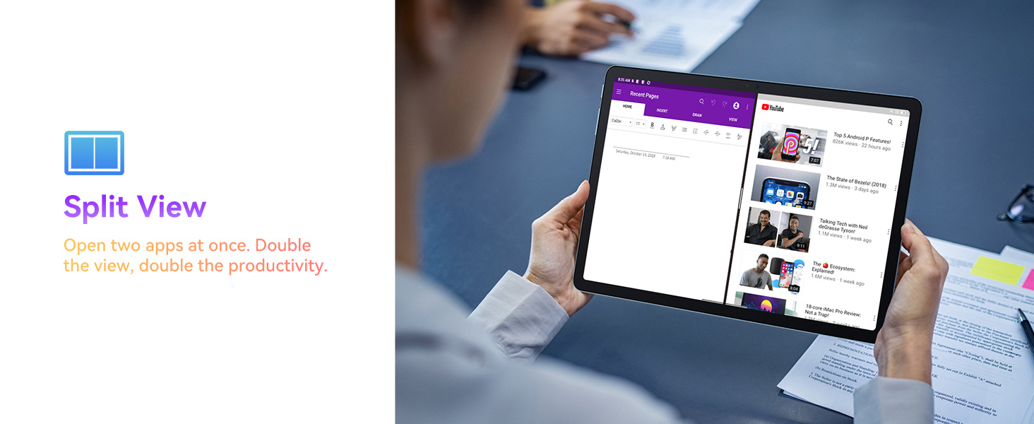 Tablet device displaying split-screen functionality, showing multiple app windows simultaneously. Held by hands over a desk with papers.