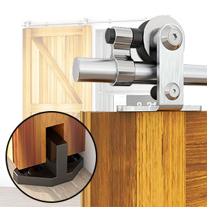 Stainless steel barn door hardware with roller mechanism. Inset shows floor guide. Mounted on light wood door frame.