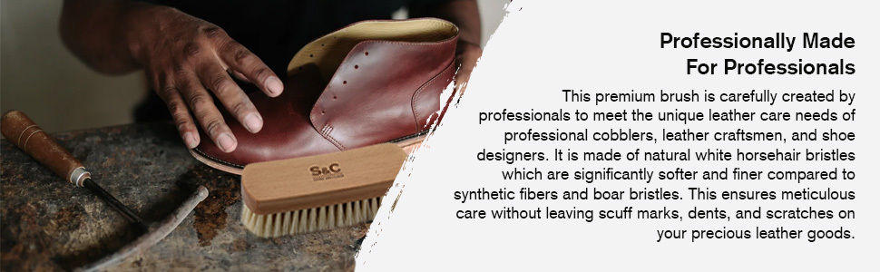 beige soft horse hair brush on cobblers table with other shoe making tools