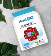 White bottle of HealthiNut MultiVitamin Plus supplement against green leaves. Label shows colorful squares with vitamin and mineral names.