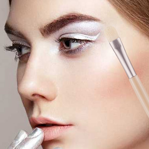 Model using eyeshadow brush