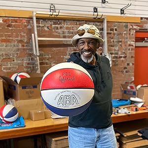 Darnell Hillman ABA legend holding the ABA Basketball