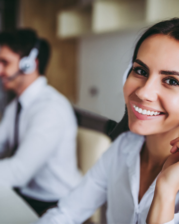 Customer service representative with a headset, smiling