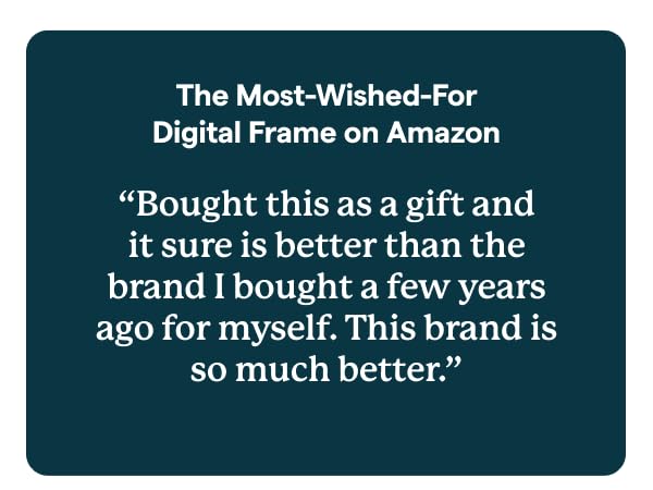 Skylight digital photo frame on table, with hand holding phone.