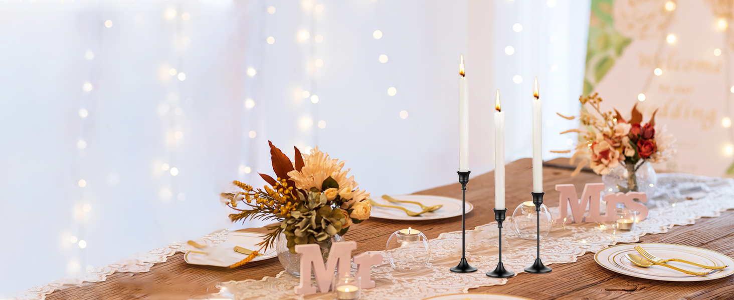 a table set with a candle and a vase with flowers.
