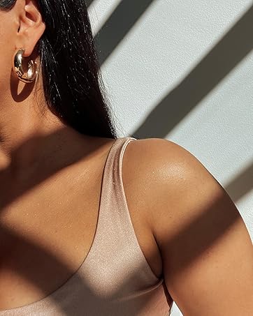 Sun shining on brown skinned woman