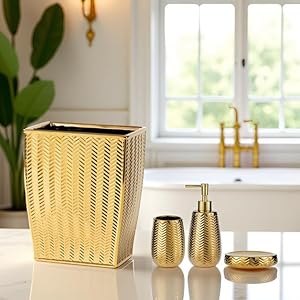 gold bathroom accessories and trash can