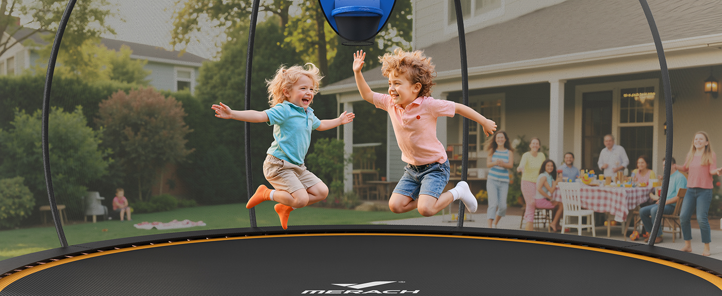 Two children jumping on a large outdoor trampoline with orange safety padding. Adults and a house visible in the background.