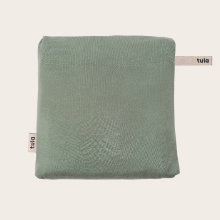 Product shot of Tula's Tencel baby wrap carrier in Sage green. Tula logo fabric labels are shown.
