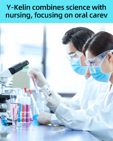 Scientists in lab coats and protective gear working with laboratory equipment. Colorful liquids in test tubes and beakers visible on the workbench.