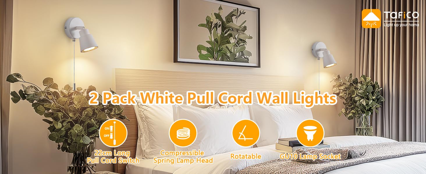 Two white pull-cord wall lights mounted beside a bed, illuminating a bedroom space with potted plants and wall art.
