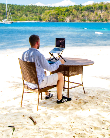 Working on a laptop stand on the beach