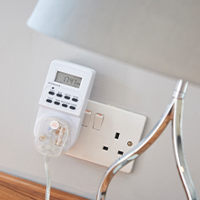 a wall socket with a timer and a lamp