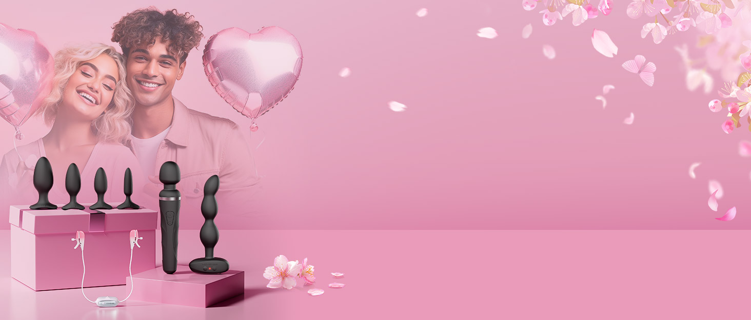 Assortment of black silicone or rubber objects of various shapes and sizes, displayed on a pink background with floating heart shapes.
