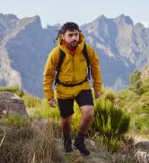 man walking in yellow jacket