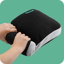 hands rolling up small pillows for travel