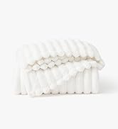 Decorative textured surface with repeating geometric pattern in white, creating a dimensional, quilted appearance.