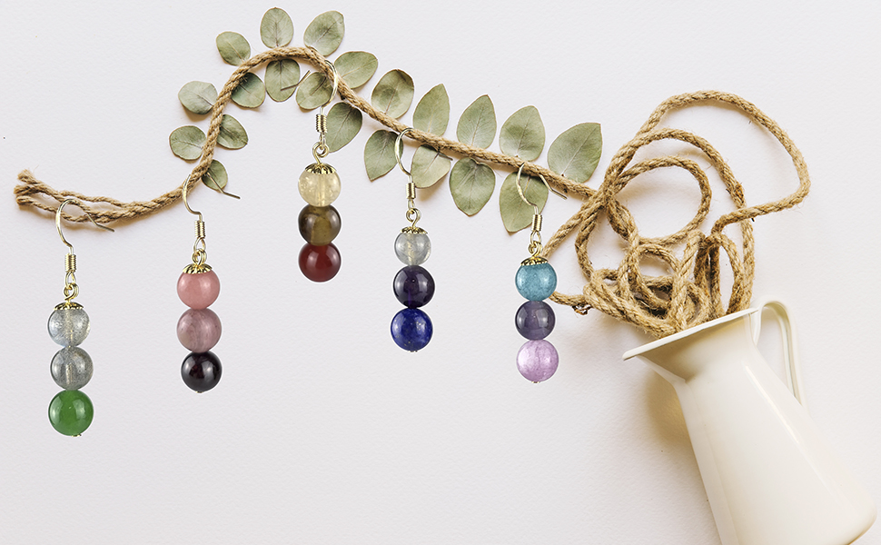 dagnling gemstone earrings with symbolism