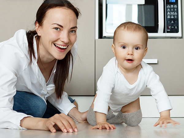 baby crawling on tile floor