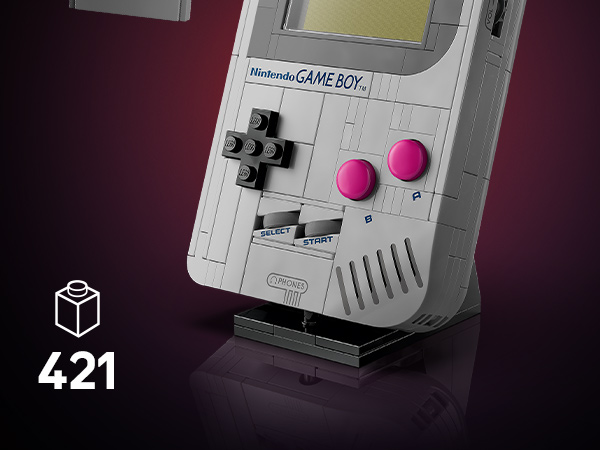 Original Nintendo Game Boy handheld gaming device shown in dramatic lighting against dark background, highlighting its classic gray exterior and signature control layout.