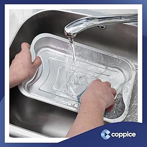 Foil tray being washed under running tap