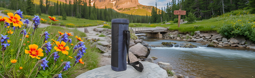 A scenic mountain landscape with a product resting on a rock.