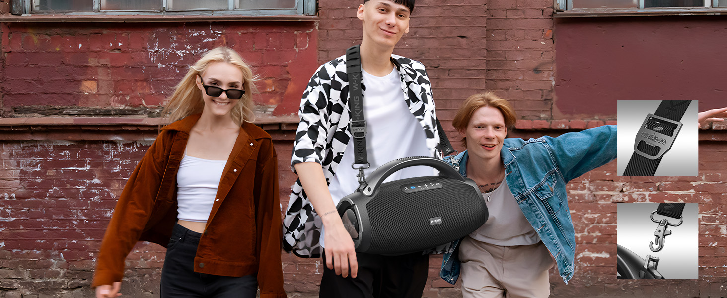 a man holding a portable speaker in his hand