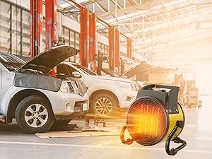 La unidad de calefacción o ventilador industrial se muestra en el entorno de un taller de reparación de automóviles con los automóviles en los ascensores en segundo plano, con un efecto de brillo naranja visible.