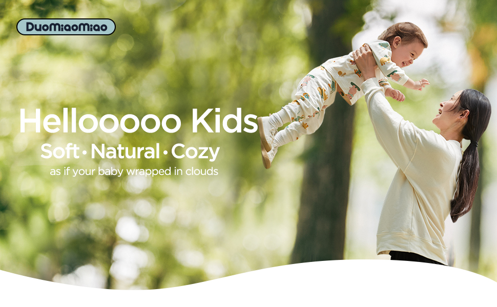 Advertisement for soft, natural, and cozy baby clothing. Shows a person lifting a baby wearing a light-colored onesie in an outdoor setting.