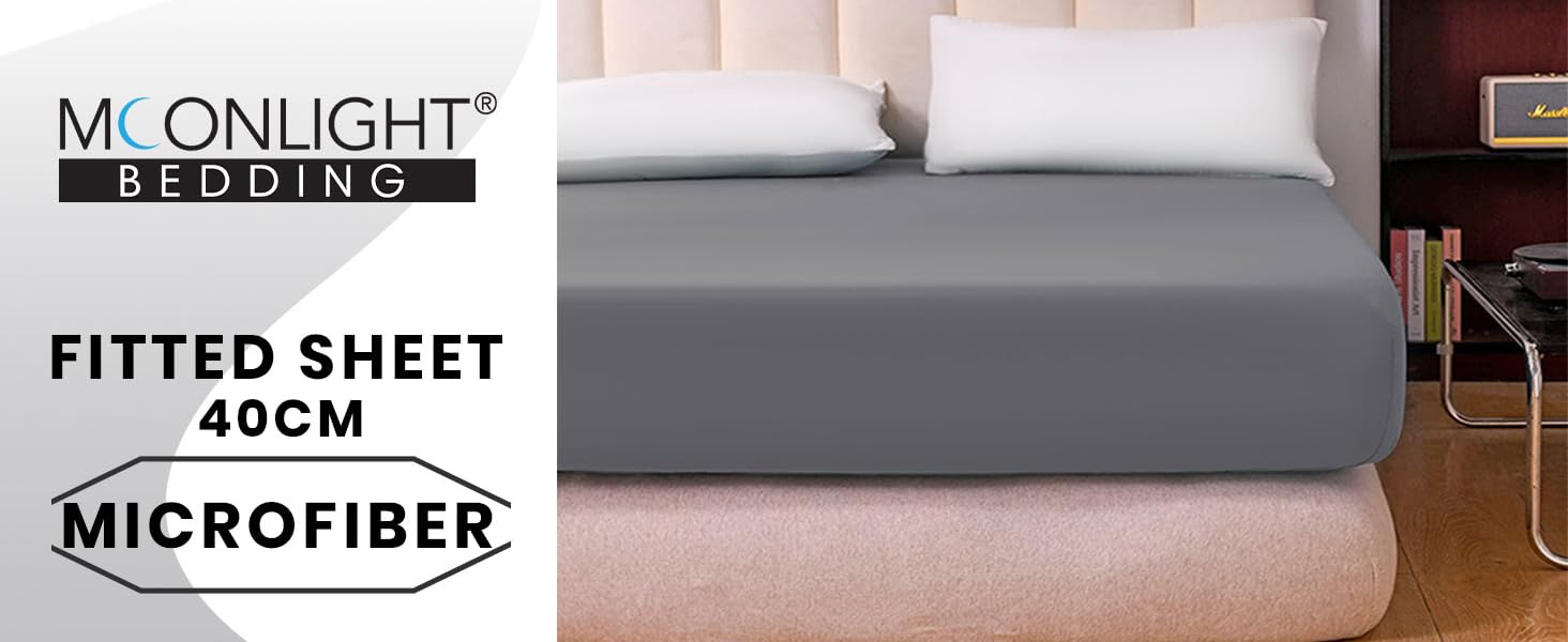 Moonlight Bedding fitted sheet, 40cm deep, made of microfiber. Gray sheet shown on a bed with white pillows in a bedroom setting.