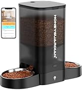 Smart automatic pet feeder with transparent container showing dry food, two metal bowls, and a smartphone displaying the control app interface.