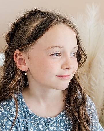 little girl wearing dangling puff heart earrings