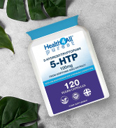 White bottle of 5-HTP dietary supplement. Label shows 120 vegetarian capsules, 100mg strength. Green leaves in background for natural health emphasis.