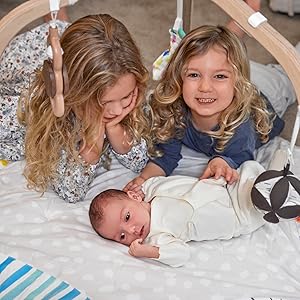 Toddlers playnig with baby on Play Mat