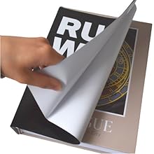 Removing black New York dust cover from cream Prague decorative book