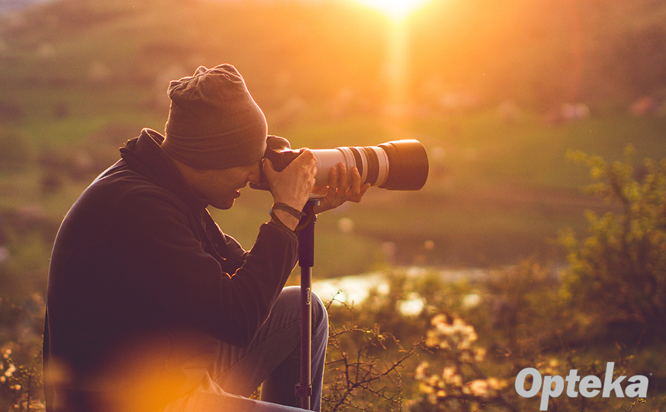 A man uses the Opteka MP172 Monopod with a large telephoto lens' tripod collar.