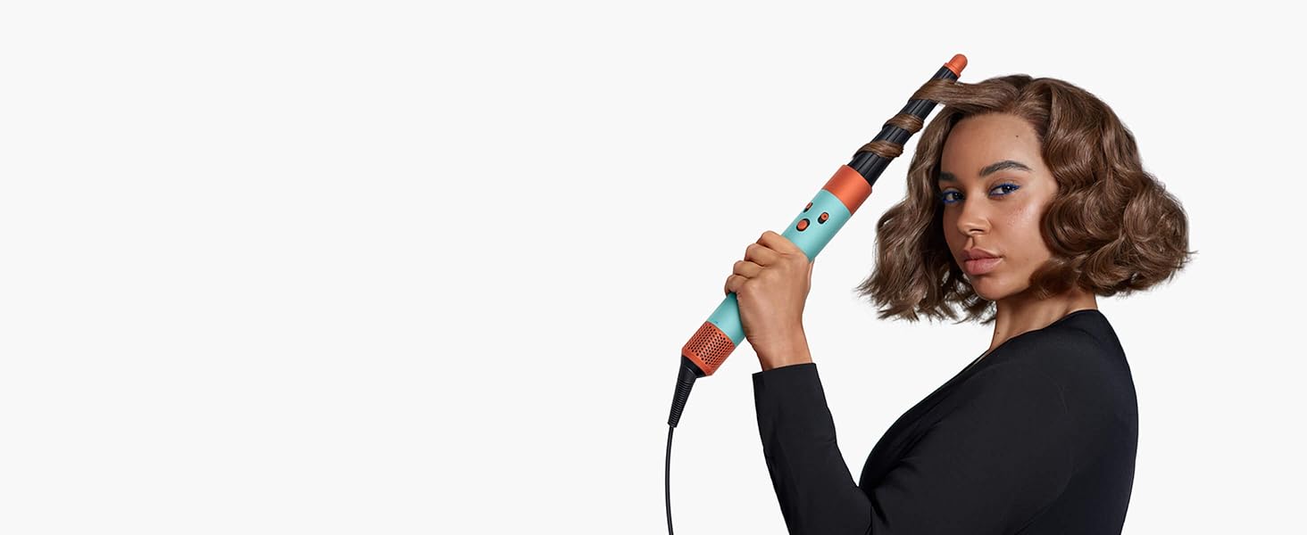A model with chin-length brown hair uses the Conical Airwrap barrel to add waves to her hair.