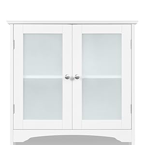 White wooden bathroom cabinet with two glass-paneled doors, featuring a curved base and silver knobs. Suitable for storage in bathrooms or other spaces.