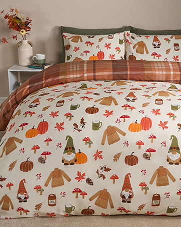 Bedding set featuring autumn-themed pattern with pumpkins, gnomes, mushrooms, and fall leaves in orange, brown, and white colors on duvet cover and pillowcases.