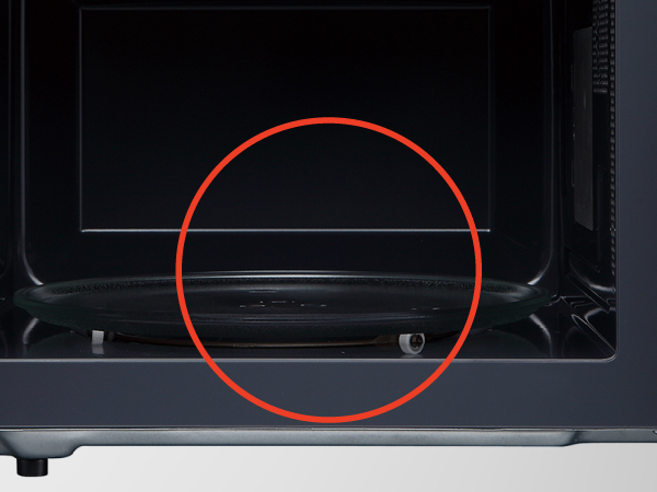  The inside of a small countertop microwave. Text reads: Glass turntable. 