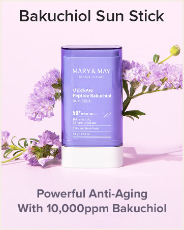 Mary & May Vegan Peptide Bakuchiol Sun Stick, SPF 50+. Purple cylindrical container with white base, surrounded by purple flowers. Text indicates anti-aging properties with 10,000ppm Bakuchiol.