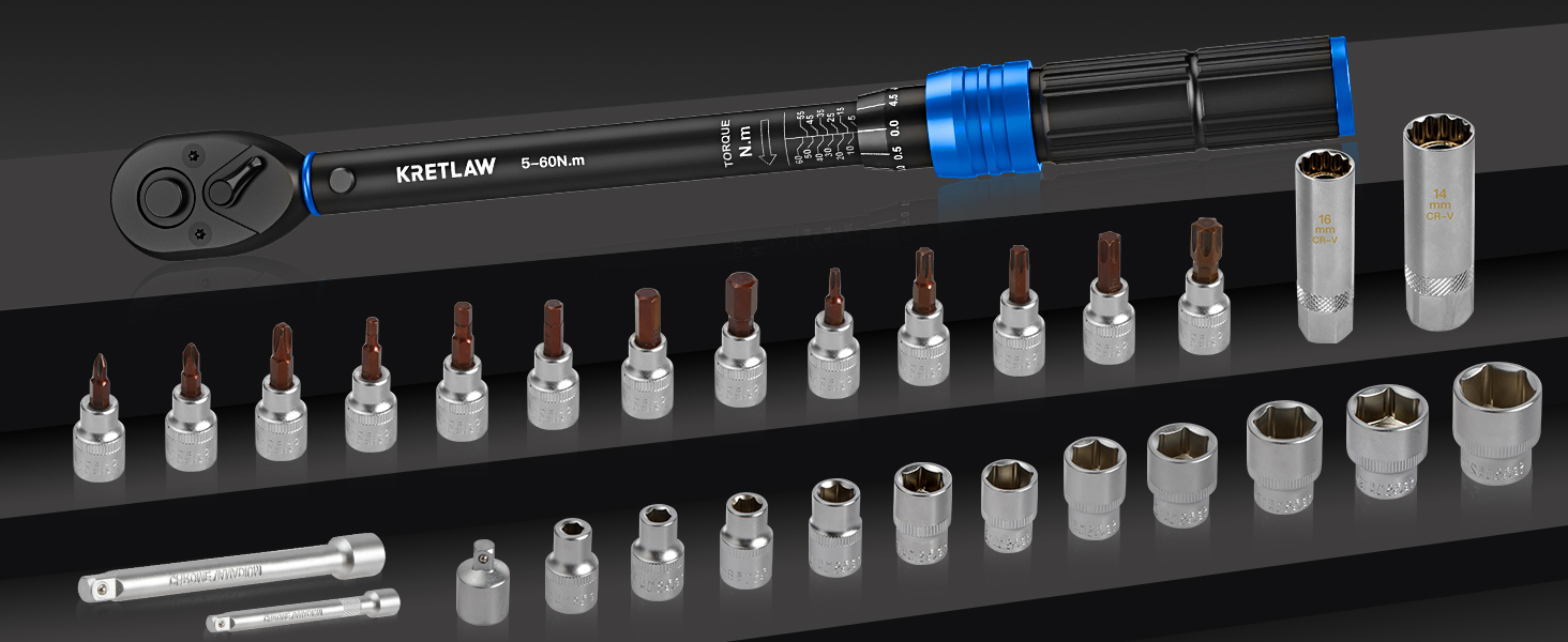 Professional socket set with torque wrench, extension bar, and multiple sized sockets arranged neatly in a row on a dark surface.