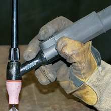 A welder shows the proper way to hold a torch when big welding