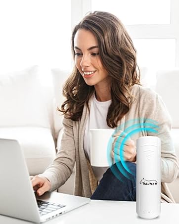 White insulated tumbler with glowing interface indicator, shown on desk next to laptop during use.