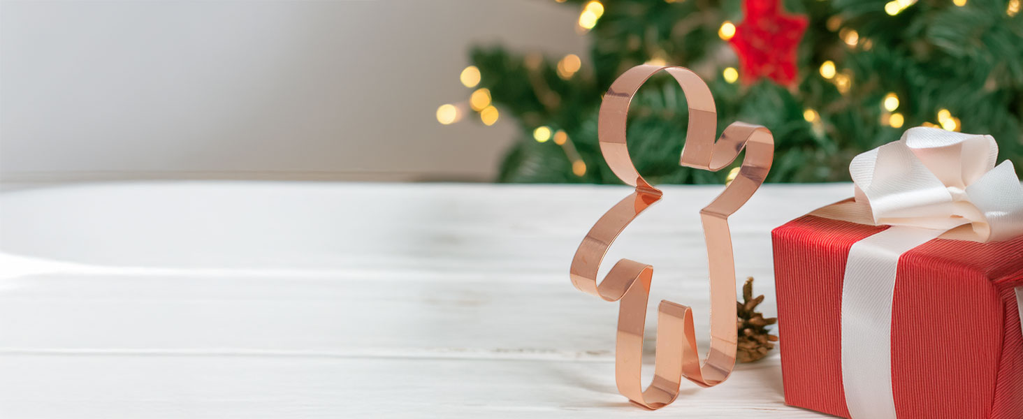The Gingerbread Boy Cookie Cutter beautifully packaged as a gift alongside holiday decor