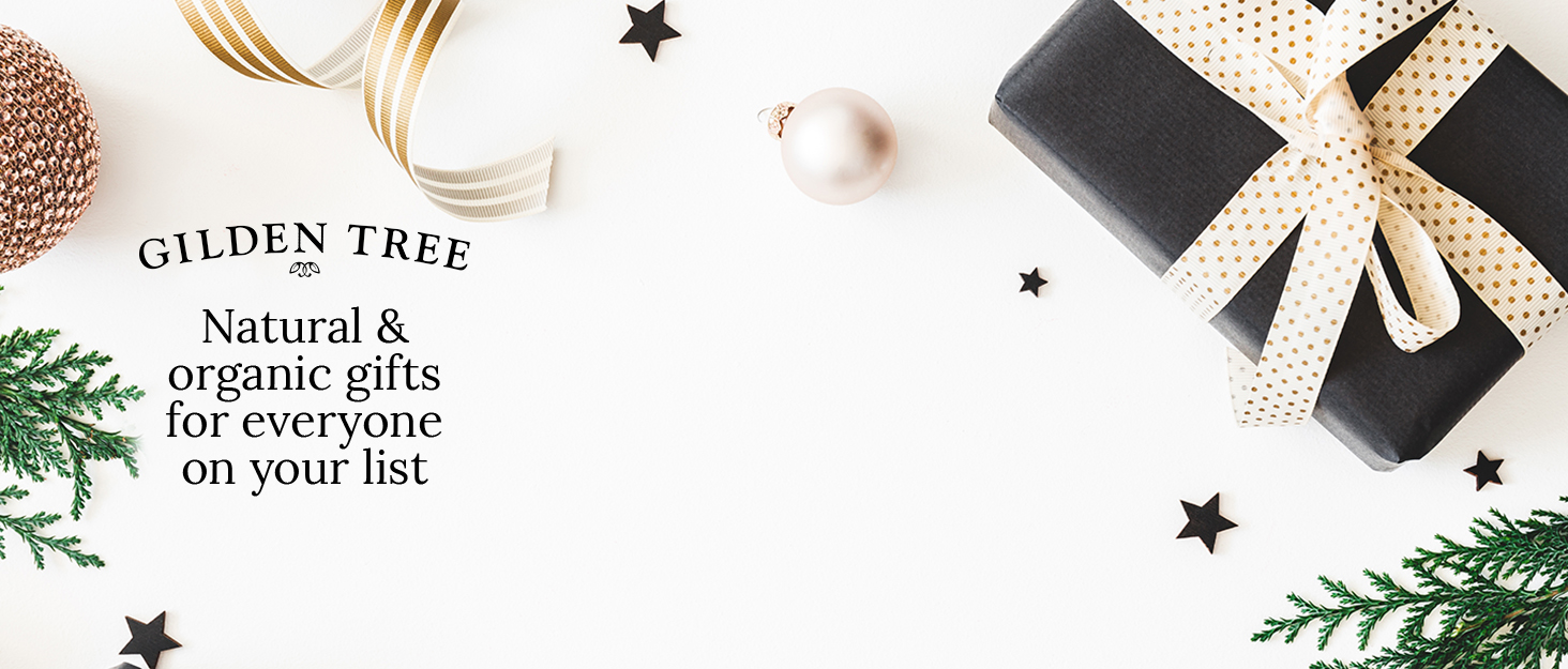 Holiday ribbon, ornaments, gifts and greenery on white background